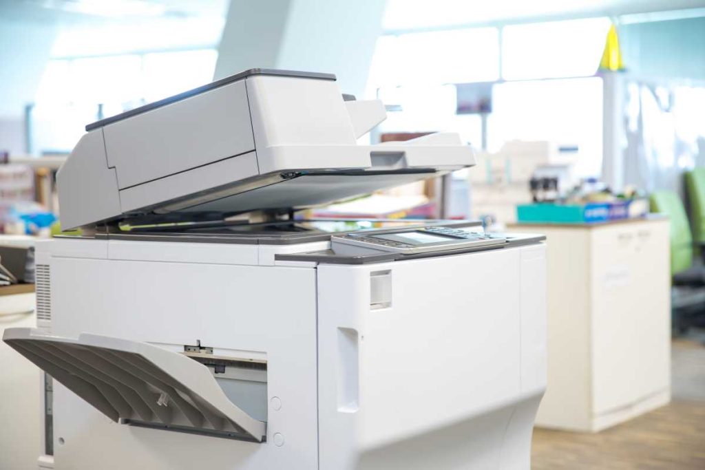 Multifunction printer in home office setting, for printing, scanning, copying, and faxing.
